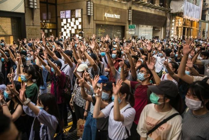 Hong Kong protesters rally against a sweeping new national security law that has prompted some Western nations to offer those from the city refuge