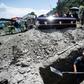 A grave is dug while a family waits during a funeral for a COVID-19 victim at the San Miguel Xico cemetery in Mexico