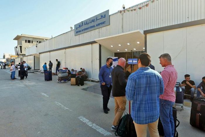 Passengers wait to depart Libya's Mitiga International Airport in Tripoli as flights resume