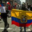 A protester holds an Ecuadorean flag during a demonstration in Quito against wage and budget cuts imposed by the government to tackle the coronavirus pandemic