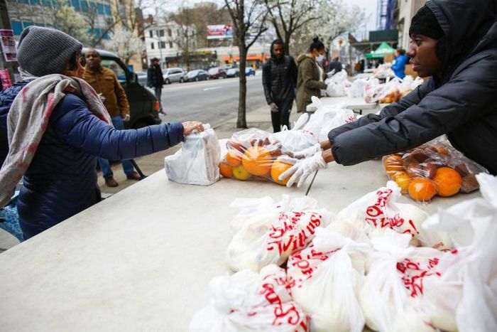 Volunteers from City Harvest food bank distribute food in Harlem, New York City