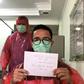 Doctor Muhammad Farras Hadyan, wearing a raincoat because of a shortage of proper protection gear, poses for a selfie during a break from treating patients with coronavirus, in Jakarta