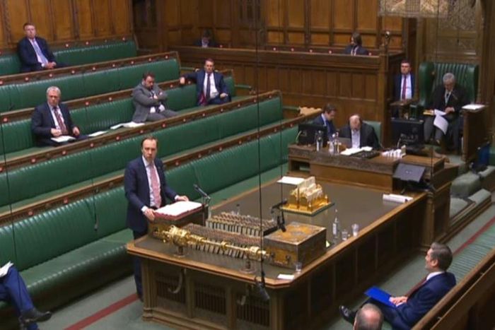 Britain's Health Secretary Matt Hancock makes a statement in parliament with social distancing measures in place