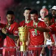 Thiago Alcantara touches the German Cup trophy after Bayern Munich's 4-2 triump over Bayer Levekursen in Saturday's German Cup final.