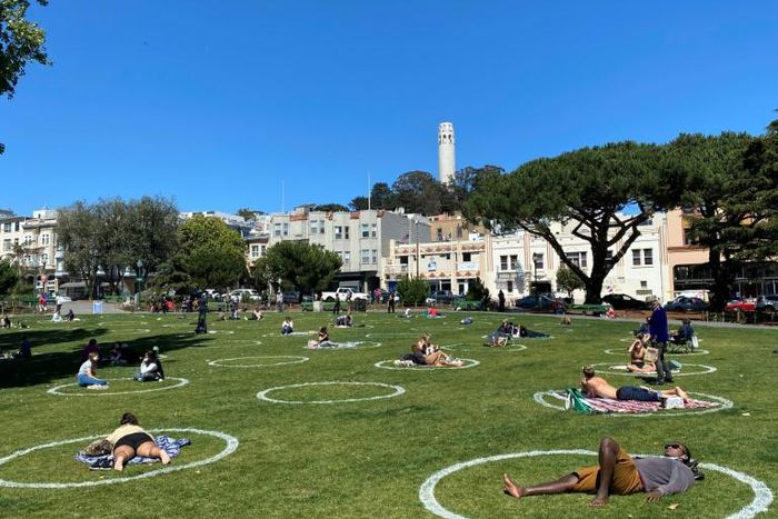 People practice social distancing at Washington square park in San Francisco