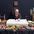 A doll depicting Israeli Prime Minister Benjamin Netanyahu sits at a table simulating the "Last Supper" during a protest performance by Israeli artist Itay Zalait on July 29, 2020 at Rabin Square in Tel Aviv