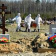 Cemetery workers in protective gear bury a coronavirus victim at a cemetery on the outskirts of Saint Petersburg. Russia has reported a remarkably low death toll but critics have cast doubt on the numbers
