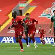 Sadio Mane (centre) celebrates his 20th goal of the season for Liverpool