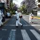 Cleaning workers wearing personal protective equipment disinfect a street in Mexico City amid the COVID-19 outbreak
