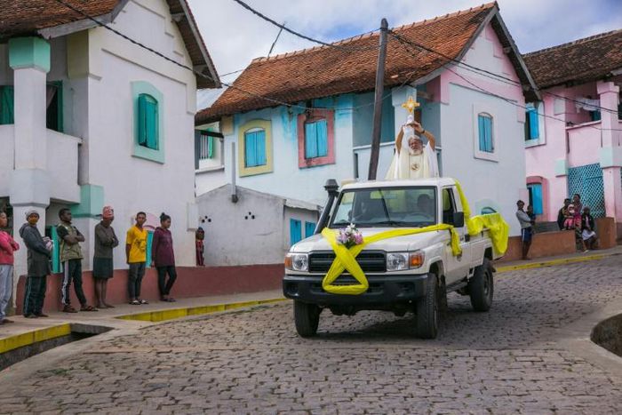 Father Pedro hopped on the back of a four-wheel drive and paraded through the town of Akamasoa