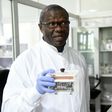 Molecular biologist Christian Happi, head of the ACEGID genomics lab, holds a thermal cycler, which amplifies genetic segments of the virus
