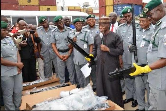 Customs boss, Hameed Ali with officers after seizing 661 pieces of riffles
