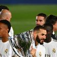 Benzema celebrates with the trophy Real clinched the title