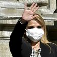 Bolivian interim President Jeanine Anez waves, while wearing a face mask, after attending a Corpus Christi procession at the Plaza de Armas in front of the government palace in La Paz, on June 11, 2020, amid the COVID-19 coronavirus pandemic