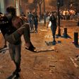A Lebanese protester carries a wounded demonstrators to safety at the headquarters of the Lebanese association of banks in downtown Beirut on August 8, 2020, following a demonstration against a political leadership they blame for a monster explosion th...