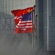 Chinese and US national flags flutter at the entrance of an office in Beijing in January 2020
