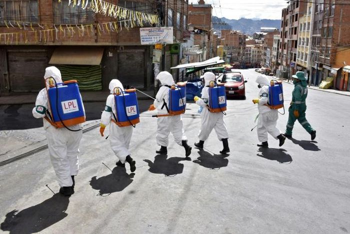 Municipal workers disinfect the streets of La Paz as a preventive measure to slow the spread of the novel coronavirus
