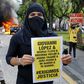 The arrests followed riots in Guadalajara after protesters had gathered to demand justice over Giovanni Lopez's death; a
demonstrator holds a banner during a protest in Guadlalajara, Jalisco