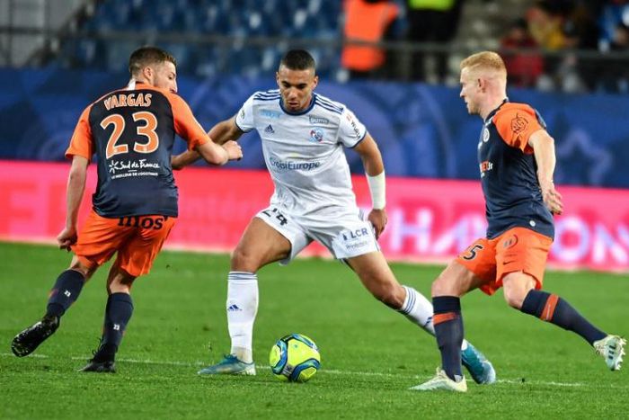Montpellier's Florent Mollet (R) in action against Strasbourg in a Ligue 1 game in February, just before the 2019/20 season was suspended because of the pandemic