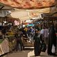 Iraqis walk through a fresh produce market in the southern Iraqi city of Basra as some lockdown restrictions imposed during the novel coronavirus pandemic have been eased