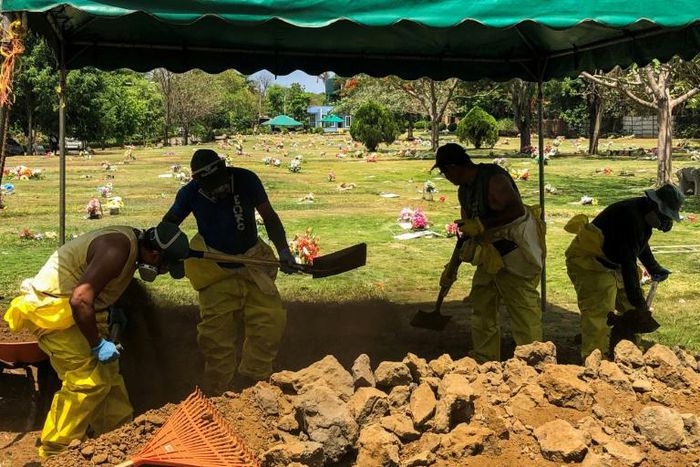 Men dig a grave at a cemetery in the Nicaraguan capital Managua