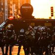 Minnesota State Police officers in front of an armored sheriff's vehicle on May 31, 2020 in Minneapolis, during a protest against police brutality after the killing of George Floyd days earlier