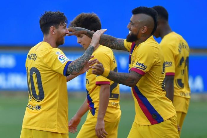 Lionel Messi (left) celebrates scoring in Barcelona's 5-0 win over Alaves on Sunday.