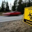 A sign reads "Quarantine COVID-19" outside the village of Pervomaiskoye near Saint Petersburg