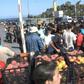 IMAGES Migrants facing homelessness after a fire ravaged Greeece's largest refugee camp rush to get food and water distributed by the governement in a supermarket parking lot where many of them are camped.