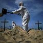 Members of the Rio de Paz NGO dig mock graves on Copacabana Beach on June 11