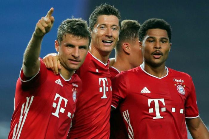 Serge Gnabry (R) celebrates with Thomas Mueller and Robert Lewandowski after scoring for Bayern Munich in their 3-0 Champions League semi-final victory over Lyon in Lisbon