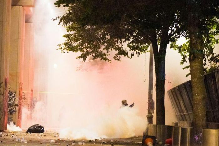 Federal police guard a courthouse in downtown Portland, Oregon as protestors rally against police brutality