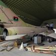 Fighters loyal to Libya's UN-recognised Government of National Accord (GNA) climb over a partially disassembled MiG 23 aircraft, after seizing Al-Watiya airbase  southwest of the capital Tripoli, on May 18, 2020.