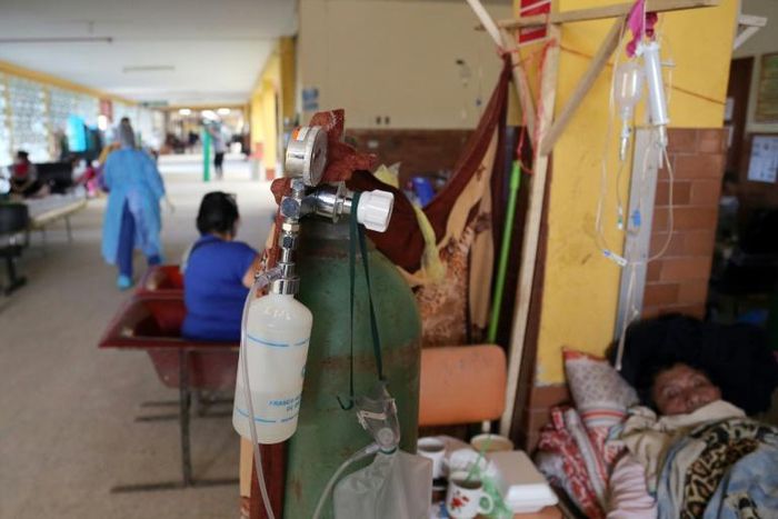 Patients with COVID-19 are treated in the corridor of a hospital in the Amazon city of Iquitos, on May 14, 2020