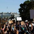 Demonstrators holding signs protest outside the White House over the death of George Floyd