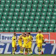 Raphael Guerreiro (C) celebrates scoring the opening goal in Borussia Dortmund's 2-0 win at Wolfsburg in a near-empty stadium.