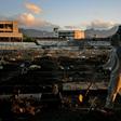 A funeral worker wearing protective clothing as a preventive measure against the coronavirus walks through Caju Cemetary in Rio de Janeiro on May 9