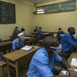 Students at the Jean Tabi high school in Yaounde wear facemasks and visors on the first day back in the classroom