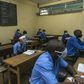Students at the Jean Tabi high school in Yaounde wear facemasks and visors on the first day back in the classroom