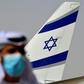 An Emirati official stands near the El Al aircraft which carried a US-Israeli delegation to the UAE on the first ever direct commercial flight following their normalisation accord