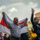 A man holds a historical Belarus flag atan opposition rally in Minsk -- growing protests against President Lukashenko and resulting uncertainty have sent the local currency tumbling