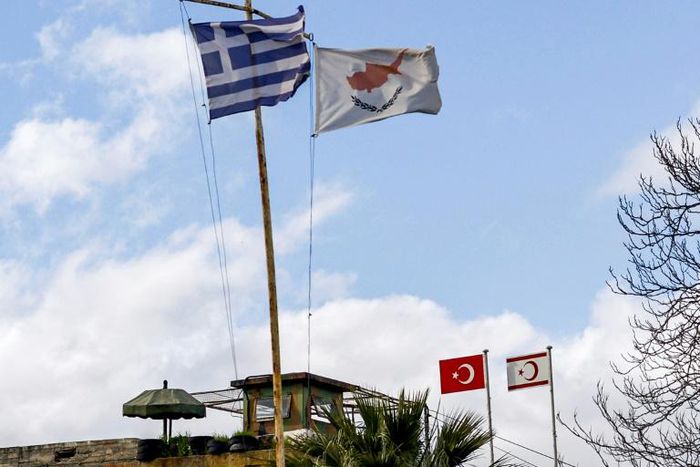 The flags of Greece, Cyprus, Turkey and the self-proclaimed Turkish Republic of Northern Cyprus (TRNC) fly above security outposts in the divided Cypriot capital Nicosia