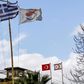 The flags of Greece, Cyprus, Turkey and the self-proclaimed Turkish Republic of Northern Cyprus (TRNC) fly above security outposts in the divided Cypriot capital Nicosia