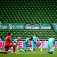 Werder Bremen and Wolfsburg players take a knee in solidarity with protests in the USA over the death of George Floyd