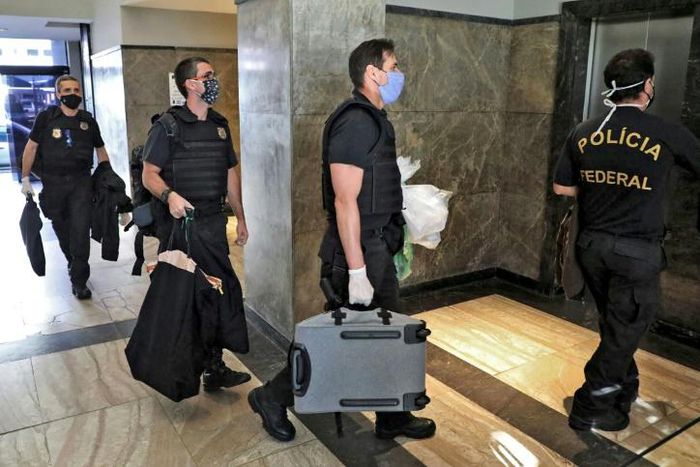 Federal police officers, pictured here carrying seized evidence, raided the residence of the governor of Rio de Janeiro, Wilson Witzel, as part of an anti-corruption investigation