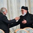 Taliban spokesman Mohammad Abbas Stanikzai (right) greets a participant during the opening of talks with Afghanistan's opposition in Moscow in February 2019