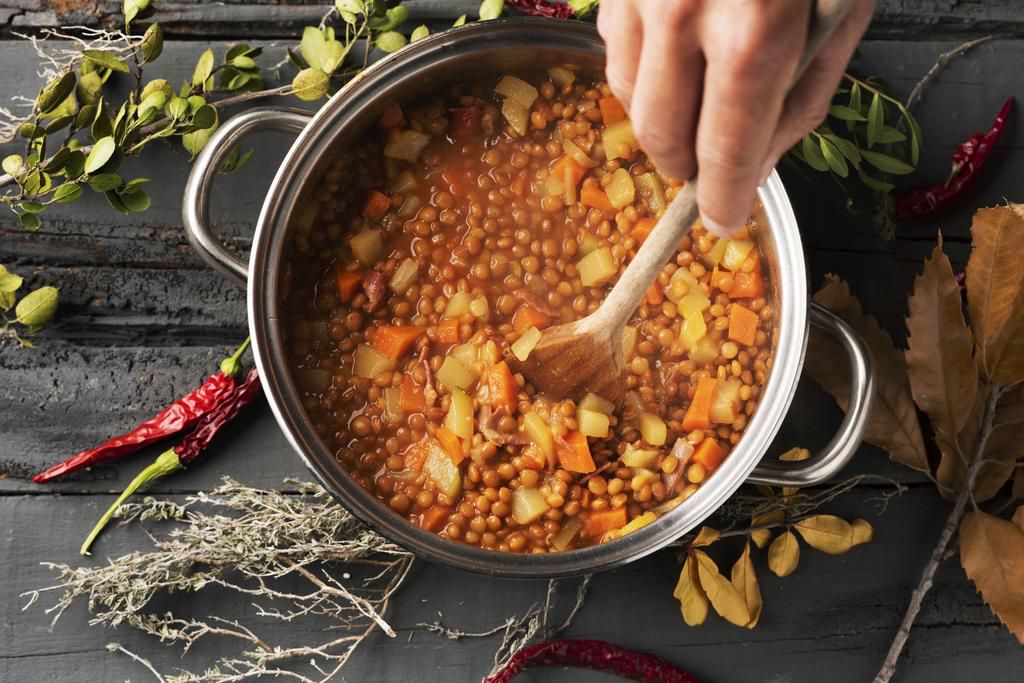 man preparing a vegetarian lentil stew