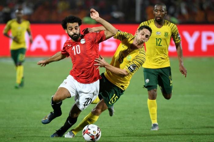 Liverpool and Egypt star Mohamed Salah (L) and Dean Furman of South Africa battle for possession during a 2019 Africa Cup of Nations last-16 clash in Cairo.