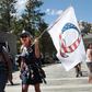 A Donald Trump supporter holding a QAnon flag at Mount Rushmore National Monument in South Dakota