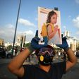 A Lebanese protester carries a photo of three-year-old Alexandra, who was fatally injured in the port explosion